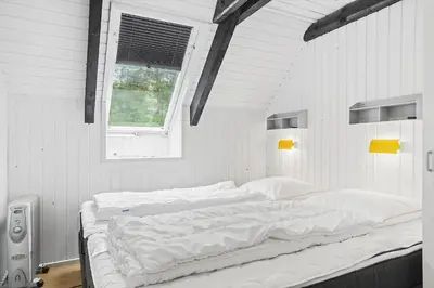 a large bed in a white room with a window at 621-Thisted-Molgaardsvej-21 in Thisted