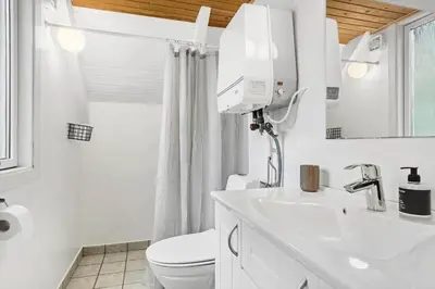 a white bathroom with a toilet and a sink at 621-Thisted-Molgaardsvej-21 in Thisted