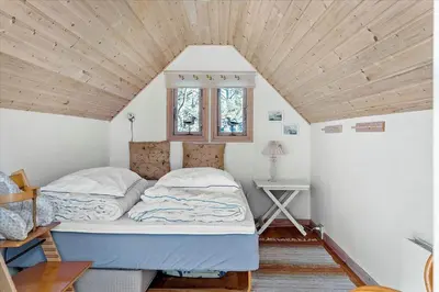 a bed in a room with a wooden ceiling at 711-Thisted-Blamunkevej-24 in Thisted