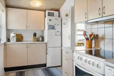 a kitchen with white appliances and a white refrigerator at 711-Thisted-Blamunkevej-24 in Thisted