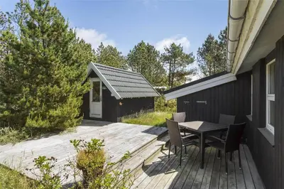a wooden deck with a table and chairs on it at 711-Thisted-Blamunkevej-24 in Thisted