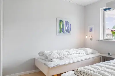 a white room with a bed and a window at 110-Vestervig-Svanholmvej-10 in Vestervig