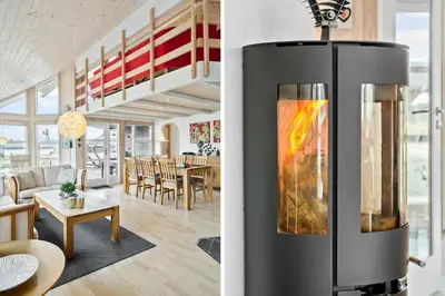 a kitchen and a living room with a fireplace at 362-Thisted-Ostersvej-1 in Thisted