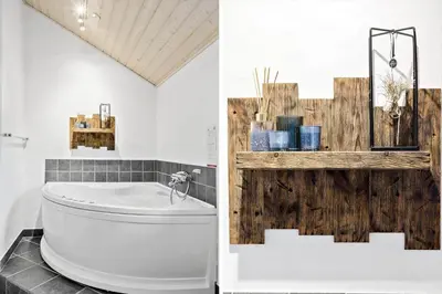 a bathroom with a white toilet and a wooden wall at 362-Thisted-Ostersvej-1 in Thisted