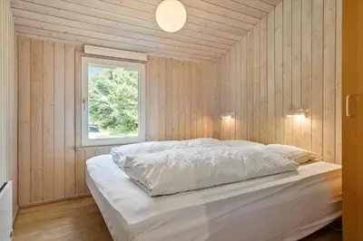a bedroom with a large white bed with a window at 466-Thisted-Muslingevej-6 in Thisted