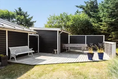 a wooden deck with a bench and a bench at 433-Thisted-Tunvej-20 in Thisted