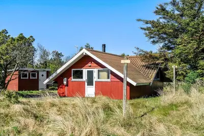 a red house sitting on top of a hill at 340-Thisted-Delfinvej-25 in Thisted
