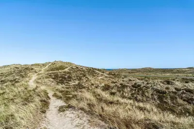 a dirt road on a grassy hill with a blue sky at 340-Thisted-Delfinvej-25 in Thisted