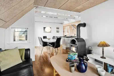 a living room with a couch and a table with a fireplace at 718-Thisted-Orredvej-36 in Thisted