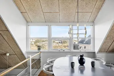 a dining room with a table and a window at 718-Thisted-Orredvej-36 in Thisted