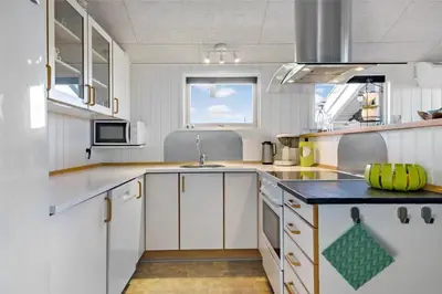 a kitchen with white cabinets and a blue counter top at 868-Thisted-Nordsovej-168 in Thisted