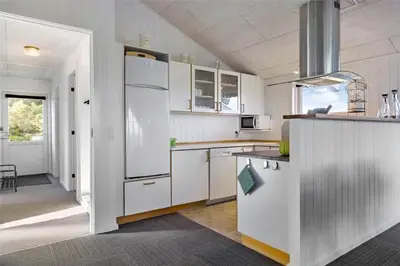 a kitchen with white cabinets and a white refrigerator at 868-Thisted-Nordsovej-168 in Thisted