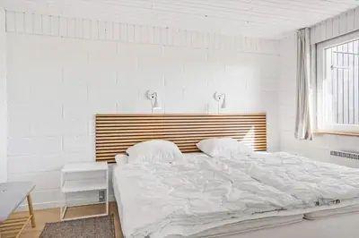 a white bedroom with a large bed and a window at 132-Thisted-Sotungevej-31 in Thisted