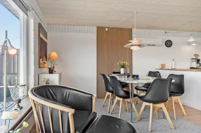 a dining room with a table and black chairs at 132-Thisted-Sotungevej-31 in Thisted