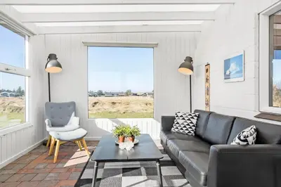 a living room with a couch and a chair at 132-Thisted-Sotungevej-31 in Thisted