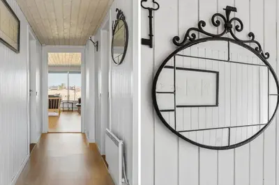 a hallway with a round mirror on a wall at 132-Thisted-Sotungevej-31 in Thisted