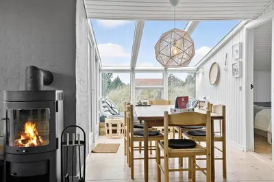 a dining room with a fireplace and a table with chairs at 635-Thisted-Store-Knuds-Vej-6 in Thisted