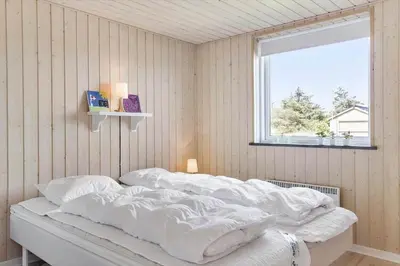 a bedroom with a bed with white sheets and a window at 524-Thisted-Flyndervej-4 in Thisted