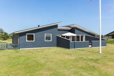 a blue house with a large yard in front of it at 524-Thisted-Flyndervej-4 in Thisted
