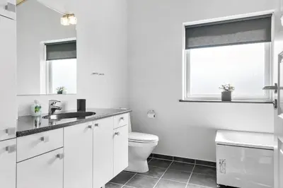 a white bathroom with a toilet and a window at 524-Thisted-Flyndervej-4 in Thisted