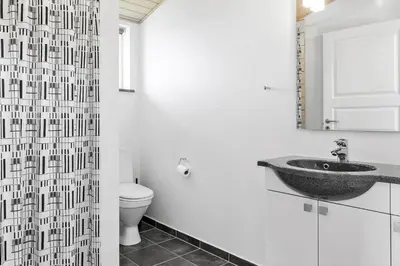 a bathroom with a sink and a shower curtain at 524-Thisted-Flyndervej-4 in Thisted