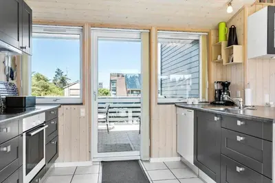 a kitchen with gray cabinets and a view of a patio at 524-Thisted-Flyndervej-4 in Thisted