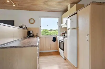 a kitchen with a white refrigerator and a window at 140-Vestervig-Bekkasinvej-14 in Vestervig