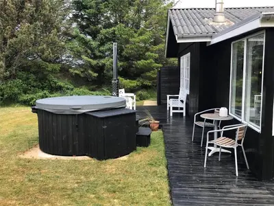 a hot tub on a deck next to a house at 140-Vestervig-Bekkasinvej-14 in Vestervig
