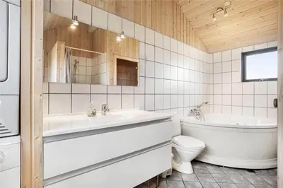 a bathroom with a tub and a toilet and a sink at 939-Thisted-Niels-Vognmands-Vej-3 in Torsted