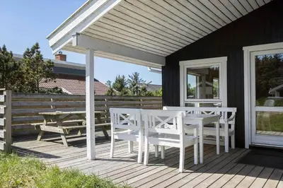 a deck with white tables and chairs on a house at 318-Thisted-Nordsovej-204-A in Thisted