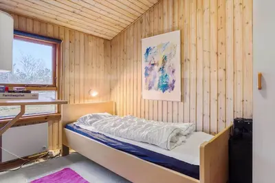 a bedroom with a bed in a wooden wall at 318-Thisted-Nordsovej-204-A in Thisted