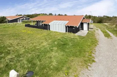a house with a red roof in a field at 970-Thisted-Klitstien-47 in Torsted
