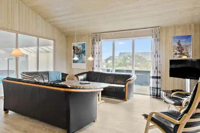 a living room with a couch and a table at 970-Thisted-Klitstien-47 in Torsted