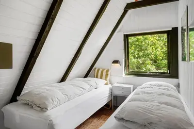 two beds in a white room with a window at 216-Snedsted-Grahavrevej-6 in Snedsted