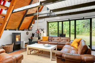 a living room with leather furniture and a fireplace at 216-Snedsted-Grahavrevej-6 in Snedsted