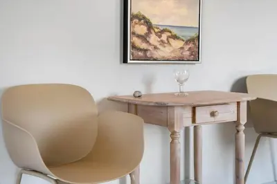 a table with two chairs and a wine glass on it at 534-Thisted-Fiskervej-123 in Thisted