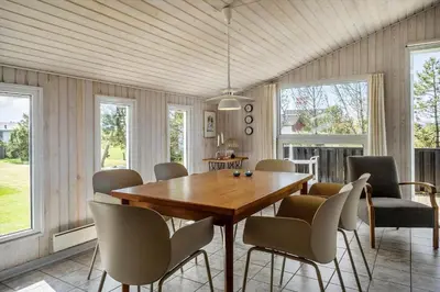 a dining room with a wooden table and chairs at 534-Thisted-Fiskervej-123 in Thisted