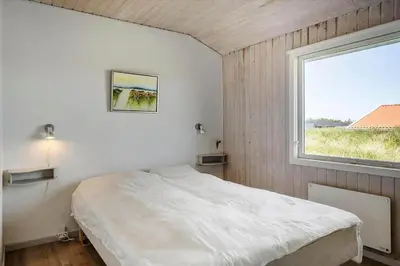 a bedroom with a white bed and a window at 534-Thisted-Fiskervej-123 in Thisted