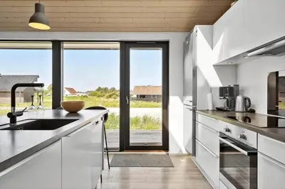 a kitchen with white cabinets and a large window at 786-Thisted-Flyndervej-6 in Thisted
