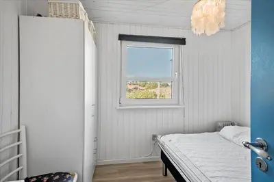 a small bedroom with a bed and a window at 767-Thisted-Nordsovej-63 in Thisted