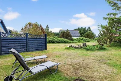 a chair sitting in the grass in a yard at 767-Thisted-Nordsovej-63 in Thisted