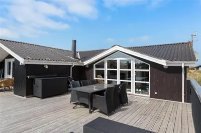 a patio with a table and chairs on a deck at 662-Thisted-Havbovej-18 in Thisted