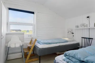 a small bedroom with a bed and a window at 662-Thisted-Havbovej-18 in Thisted