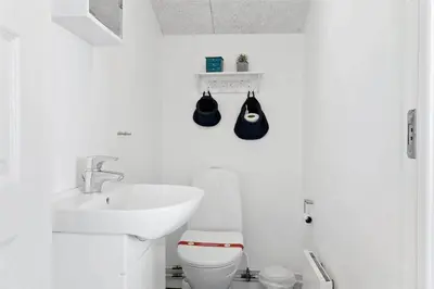 a white bathroom with a toilet and a sink at 662-Thisted-Havbovej-18 in Thisted