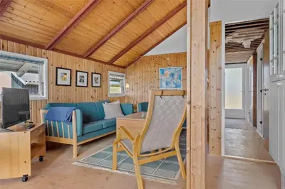 a living room with a blue couch and a table at 958-Thisted-Kobbelsti-22 in Torsted