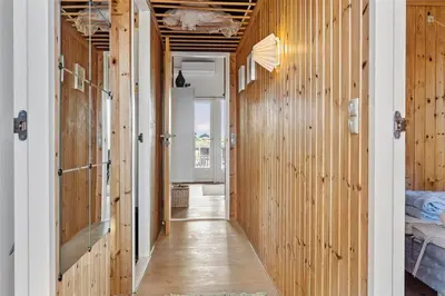 a hallway with wood paneled walls and a long hallway with a hallway at 958-Thisted-Kobbelsti-22 in Torsted