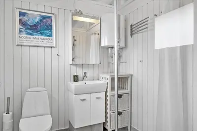 a white bathroom with a toilet and a sink at 1003-Thisted-Ajs-Molls-Vej-2 in Torsted