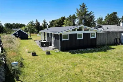 a small house in a yard next to a fence at 1003-Thisted-Ajs-Molls-Vej-2 in Torsted