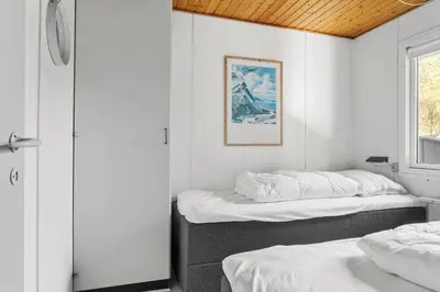 two beds in a room with white walls and a window at 837-Thisted-Flyndervej-17 in Thisted