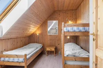 a bedroom with two bunk beds in a wooden house at 100-Thisted-Kapelvej-1 in Thisted